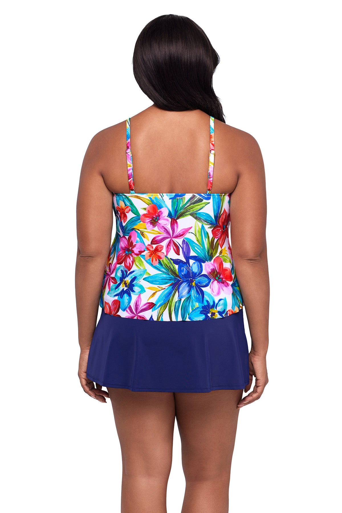 Woman wearing a colorful floral tankini top and navy bottom on a white background